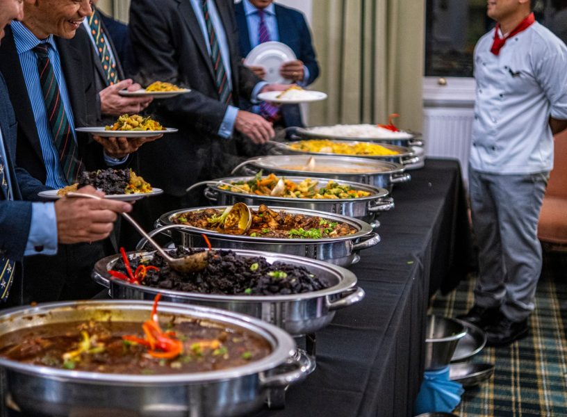 pexels-micklatter-18749086 business people at a buffet
